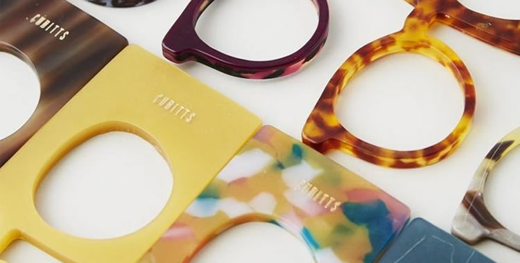 Colorful acetate eyewear frames arranged on a white surface