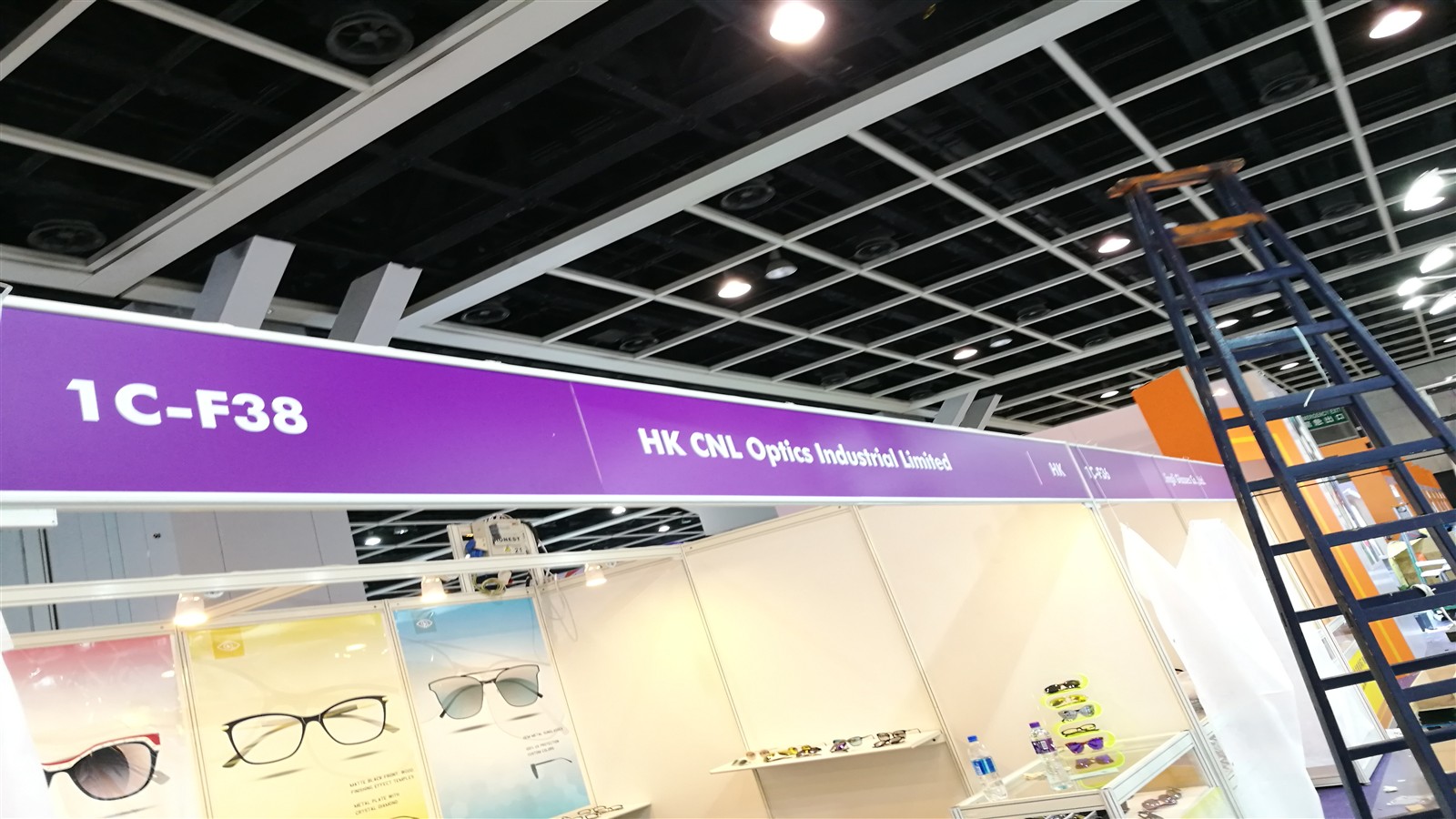 Purple exhibition banner for HK CNL Optics Industrial Limited at Hong Kong booth 1C-F38