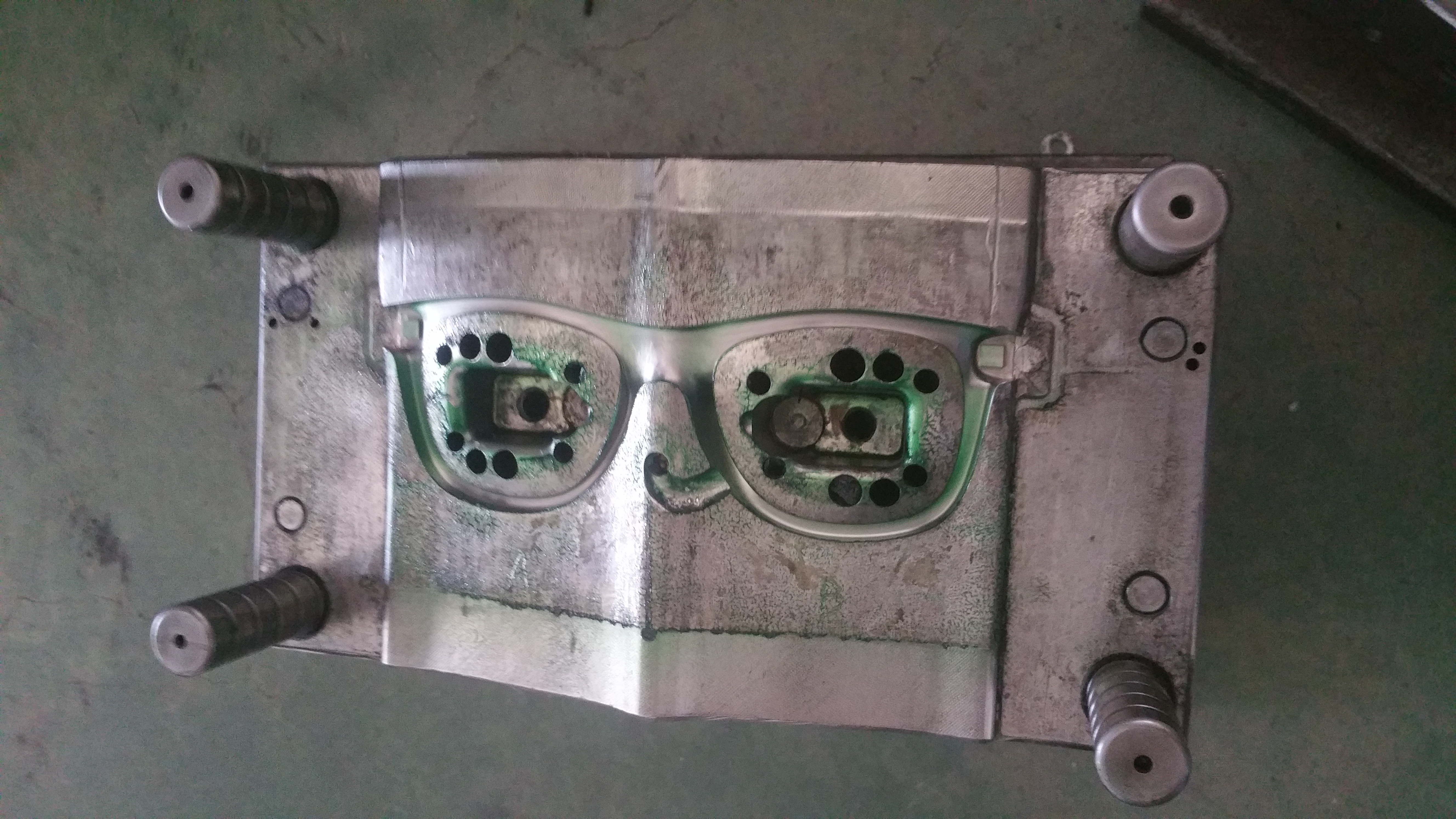 Eyewear injection mold showing the frame cavity and locating features