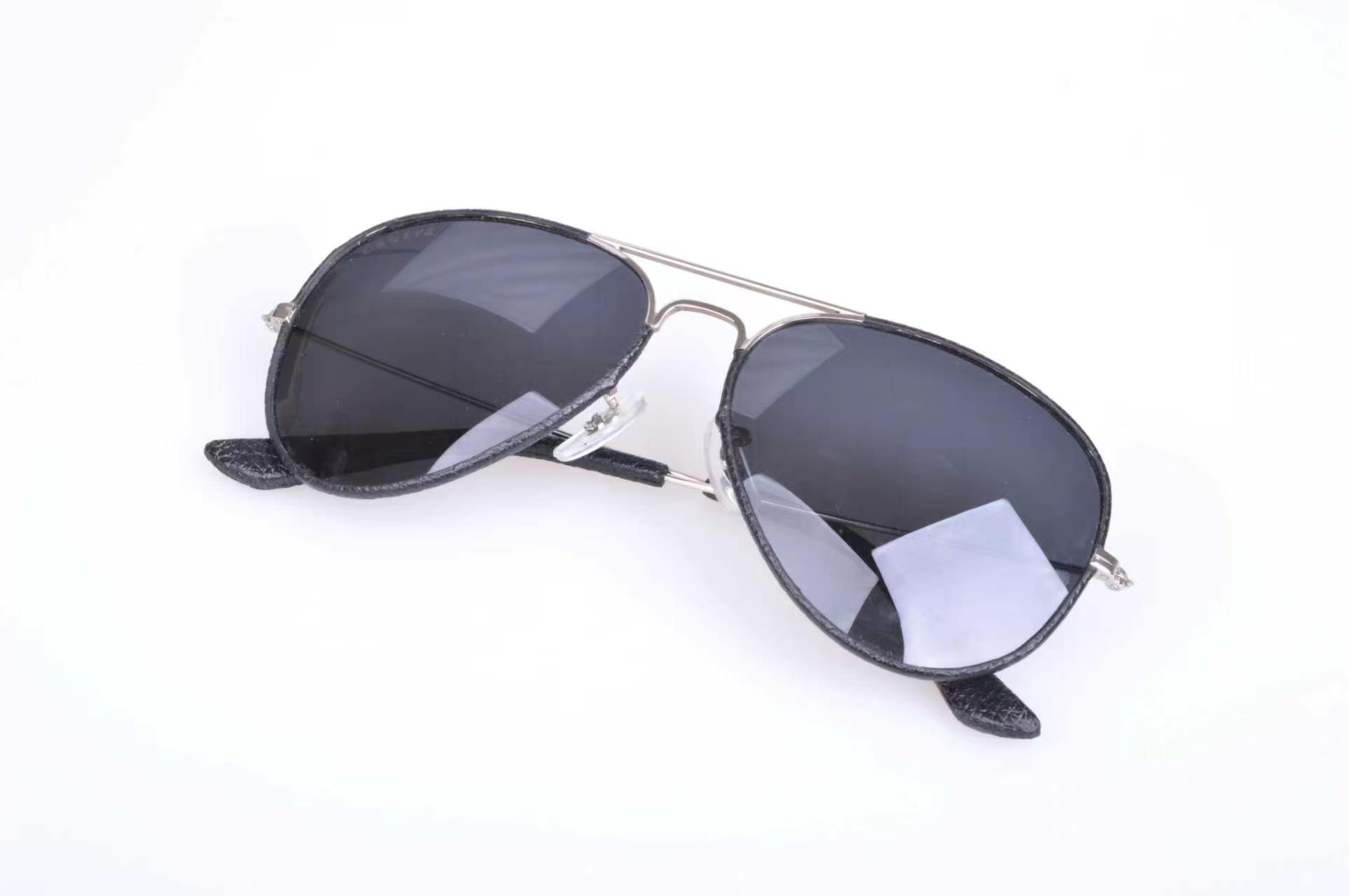 Metal aviator frame with dark leather edging around the front and temple tips