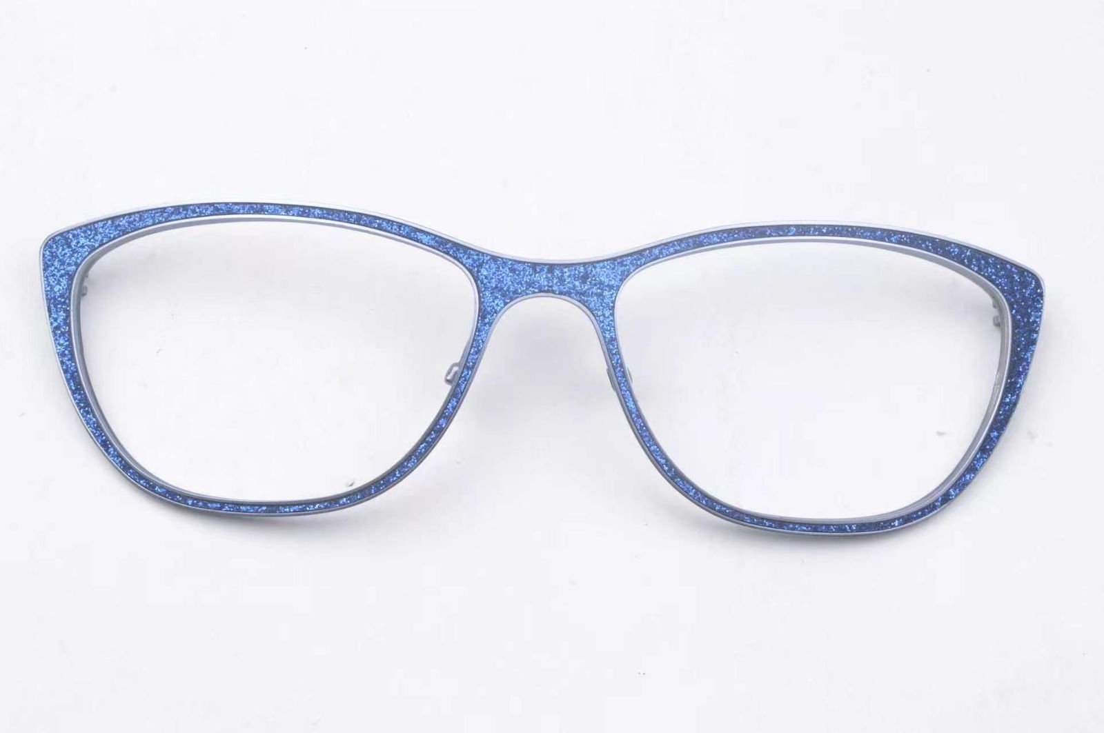Detail view of leather fitted into a groove in a metal eyewear component