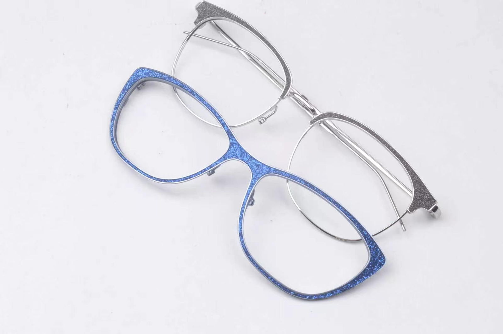 Close view of a metal eyewear component with a leather inlay