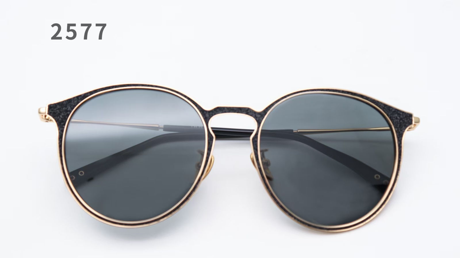 Metal eyewear frame with a leather-inlaid rim detail