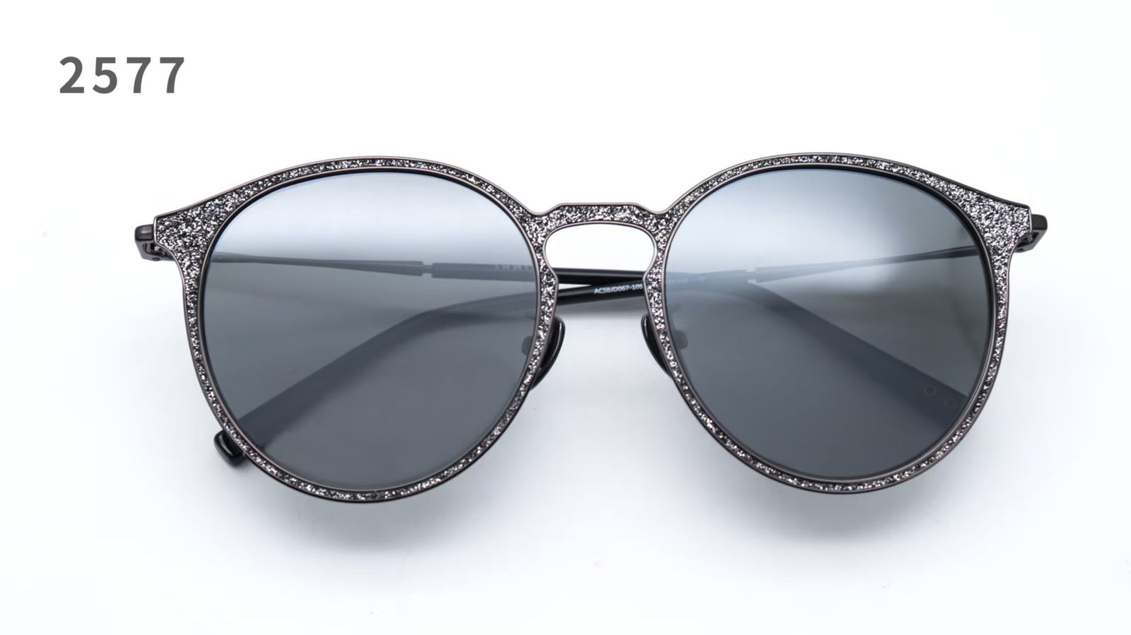 Metal eyewear frame with leather set into a machined groove along the rim