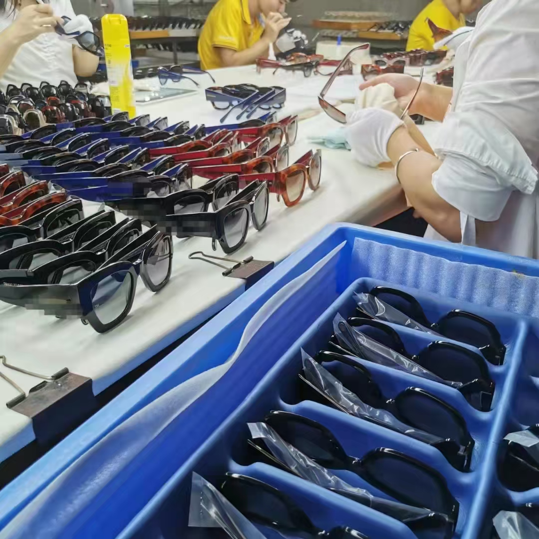 Finished sunglasses placed separately in protective tray slots during packing preparation