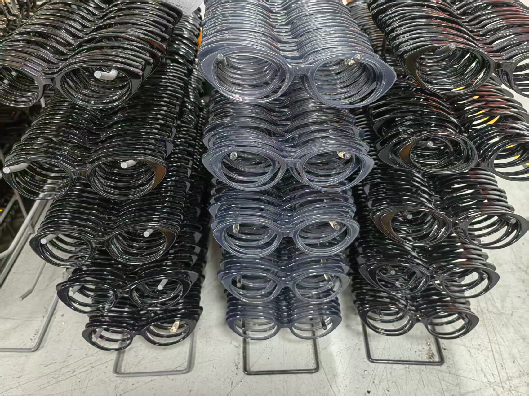 Acetate frames arranged in orderly rows on individual supports