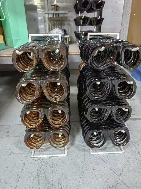 Acetate frames stacked neatly on separate supports by color